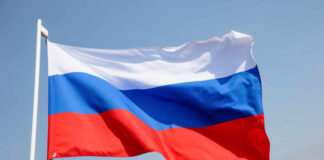 Russian flag waving against a clear blue sky