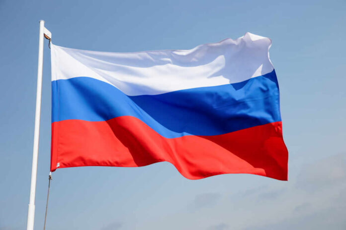Russian flag waving against a clear blue sky