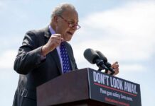 A politician passionately speaking at a podium with a sign advocating for gun safety laws