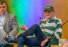 Two speakers on stage during a panel discussion at a festival