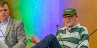 Two speakers on stage during a panel discussion at a festival