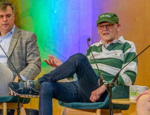 Two speakers on stage during a panel discussion at a festival