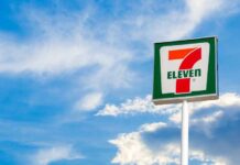 7-Eleven convenience store sign against a blue sky