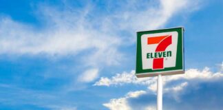 7-Eleven convenience store sign against a blue sky