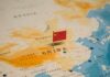 Map of China with a small Chinese flag placed on it