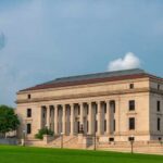 Unbelievable! Major Medicaid Fraud Conviction Tossed A historic building with columns and a red roof set against a cloudy sky