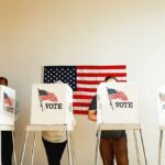 Republicans Scramble as Trump Demands Loyalty Individuals casting their votes in a polling station with an American flag in the background