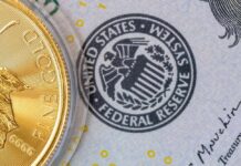 Close-up of a gold coin next to a US dollar bill