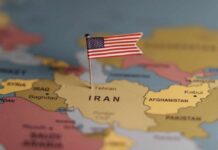 A map highlighting Iran with a small American flag pin