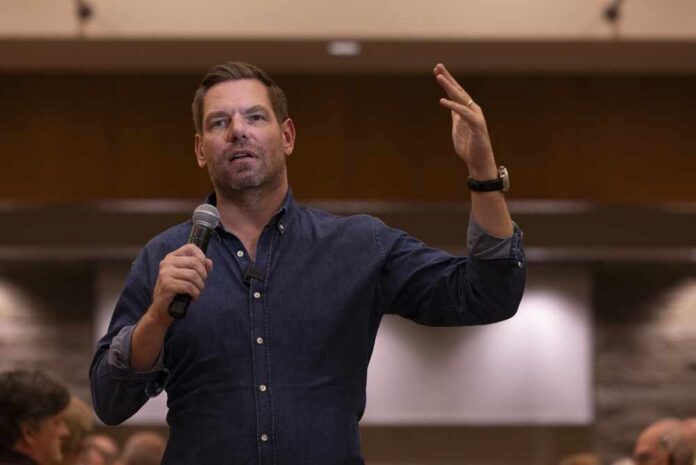 A speaker addressing an audience with a microphone in hand