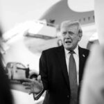 Trump Declares Blockade After Iran Refuses Surrender A political figure speaking outdoors in front of an airplane
