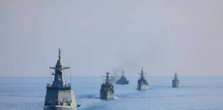 A fleet of military ships sailing in the ocean
