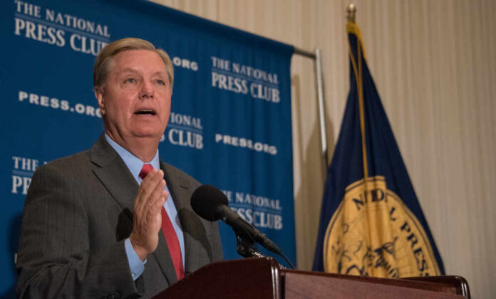 Politician speaking at a podium during a press conference