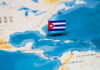 Decades Later: Cuban Leader Faces Justice for Plane Attack A small Cuban flag placed on a map highlighting Cuba in the Caribbean