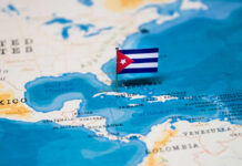 Decades Later: Cuban Leader Faces Justice for Plane Attack A small Cuban flag placed on a map highlighting Cuba in the Caribbean