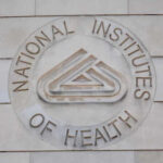 Signage of the National Institutes of Health on a building wall