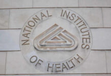 Signage of the National Institutes of Health on a building wall