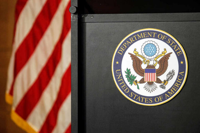 Seal of the Department of State next to an American flag