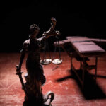 Grim Milestone: Texas Reaches 600th Execution! Statue of Lady Justice holding scales in a dimly lit setting