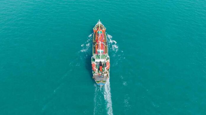 Oil,Tanker,Ship.,Red,Oil,Tanker,Runing,In,The,Ocean Aerial view of a cargo ship navigating through turquoise waters