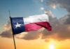 Prison Camp Plan BACKFIRES: Dem Defeated! Texas flag waving against a sunset backdrop with clouds