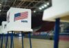 Treason Accusation Shakes Texas Election Voting booths with American flags set up in a gymnasium