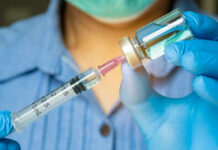 Diphtheria Outbreak LOOMS: Vax Failures EXPOSED! Healthcare professional preparing a syringe from a vial