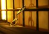 Close-up of handcuffs attached to a bed frame