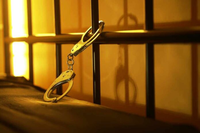 Close-up of handcuffs attached to a bed frame