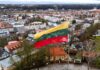 Lithuanian flag over a cityscape