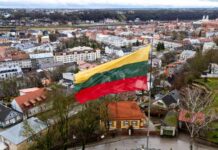 MYSTERIOUS Threat Grounds NATO Capital – Panic Ensues! Lithuanian flag over a cityscape