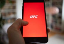 White House Turns Into UFC Fight Arena Hand holding smartphone with red app screen