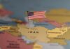 A map highlighting Iran with a small American flag pin
