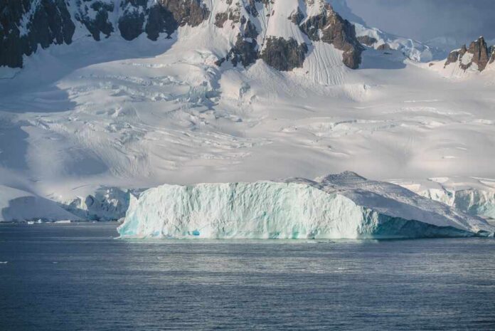 Epic,Glacier,Iceberg,Charlotte,Bay,Antarctica,Beautiful,Frozen,Landscape,With Iceberg floating near a snow-covered polar coastline