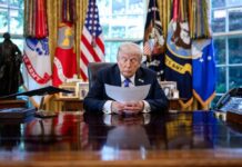 A political leader reading documents in the Oval Office