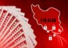 A stack of hundred dollar bills with a map of Iran and padlocks