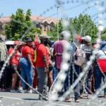 Jobs Crisis Turns Into Migrant Hunt A small South African flag placed on a map of Africa