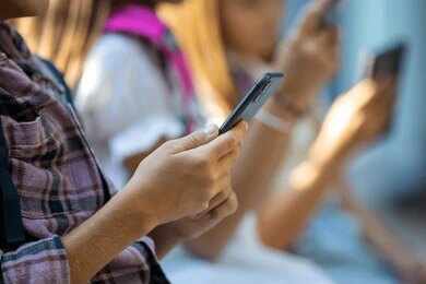 Hands of young people using smartphones