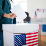 NYC Showdown: Sanctuary vs. Ballots A person casting a vote into a ballot box at a polling station