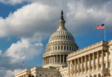 Capitol Meltdown Over FISA And Voting The U.S. Capitol building with a dome and an American flag under a cloudy sky