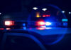 Chaotic Crossfire Mows Down Festival Crowd Close-up of police car lights flashing at night