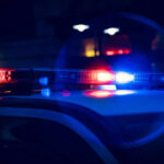 Chaotic Crossfire Mows Down Festival Crowd Close-up of police car lights flashing at night