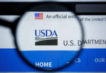 USDA Uncovers Millions in Fraud—Claims Remain Unproven Close-up view of the USDA website logo through a magnifying glass
