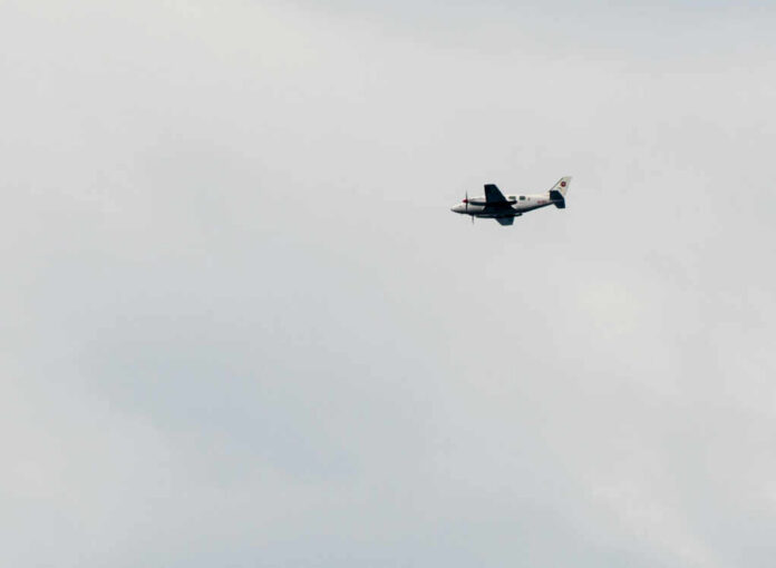 shutterstock_1507862360 An airplane flying in a cloudy sky