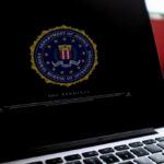 Close-up of a computer screen displaying the FBI logo and a security warning