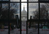 View of the Capitol building through a security fence