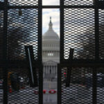 Media Spins Decades-Old Scandal At Trump View of the Capitol building through a security fence