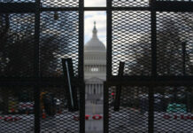 Media Spins Decades-Old Scandal At Trump View of the Capitol building through a security fence