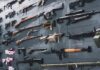 Vriginia’s Gun Ban Sparks Panic Buying Wall display of assorted firearms and weapons