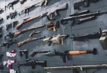 Vriginia’s Gun Ban Sparks Panic Buying Wall display of assorted firearms and weapons